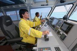 Tugboat captain communicating with local port authorities