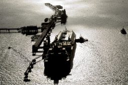 Photo of a Nakilat LNG carrier at an LNG terminal at dusk